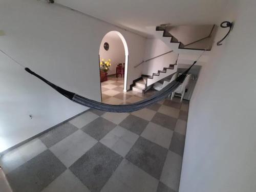 a room with a staircase and a checkered floor at Casa Villavicencio in Villavicencio