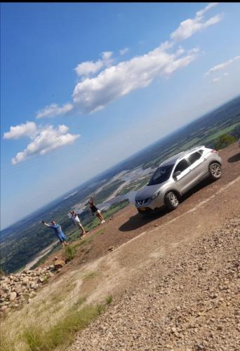 a car parked on the side of a dirt road at Casa Villavicencio in Villavicencio