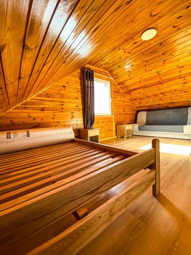 a room with two beds in a wooden cabin at Nadmorska Kępa in Kąty Rybackie