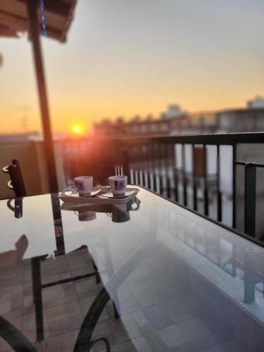 a table with two coffee cups on top of a balcony at MarGe Apt in Arta