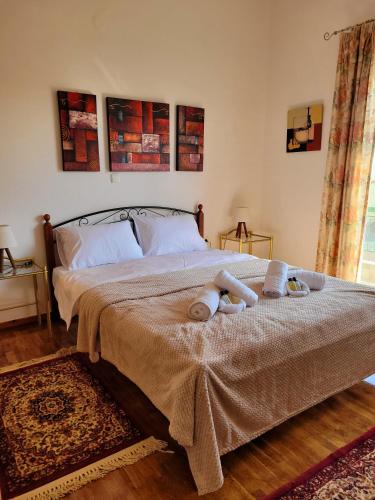 a bedroom with a bed with two towels on it at MarGe Apt in Arta