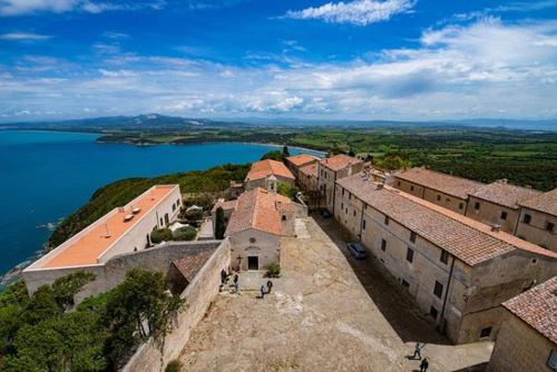 an aerial view of a building on a hill next to the water at Il Balcone sull'Elba in Piombino
