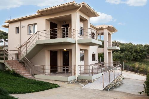 a large house with a staircase in front of it at Baywatch Hotel in Chrani