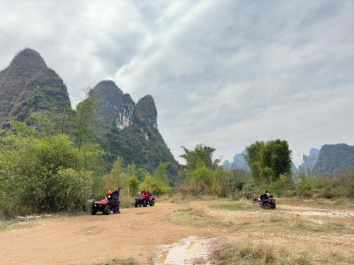 a group of people riding motorcycles on a dirt road at Lanshan Moon Resort in Yangshuo