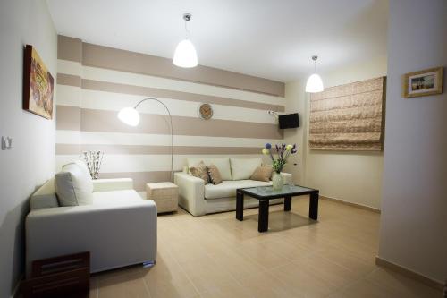a living room with a couch and a table at Baywatch Hotel in Chrani
