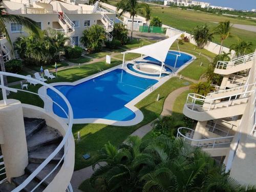 an aerial view of a swimming pool in a resort at Acapulco diamante departamento con playa ecológico in Acapulco