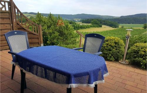 a table and two chairs with a blue table cloth at Cozy Apartment In Medebach-Düdinghausen in Medebach