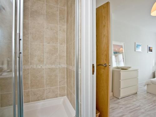 a bathroom with a shower with a bath tub at Apartment 7, Ocean 1 in Crantock