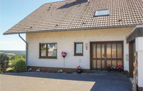 a house with a roof with flowers in front of it at Cozy Apartment In Medebach-Düdinghausen in Medebach