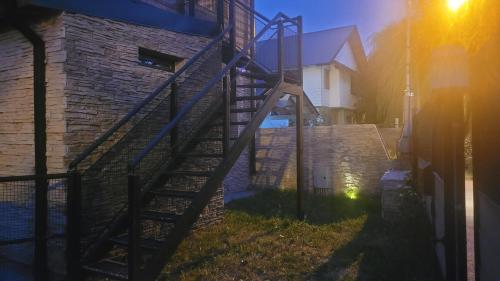 a set of stairs next to a brick building at Espacio BERNI in San Martín de los Andes