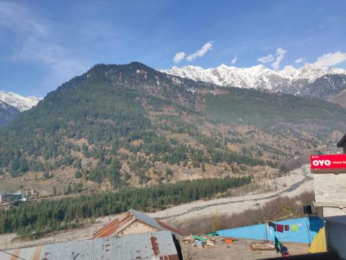 a view of a mountain with snow covered mountains at ROOP MOUNTAIN HOMESTAY No Parking in Manāli