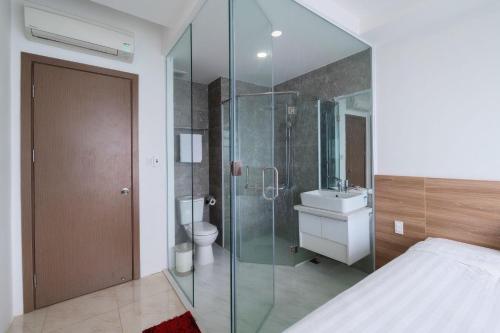 a bathroom with a shower and a toilet and a sink at MySea Nha Trang Apartments in Nha Trang