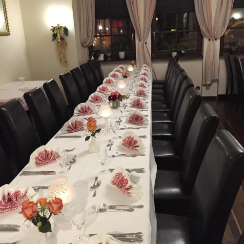 a long table with plates of food and flowers on it at Marktschänke in Bad Dürkheim