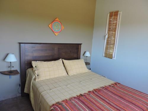 a bedroom with a bed and a kite on the wall at Lugar de PAZ en las Sierras in Sierra de la Ventana