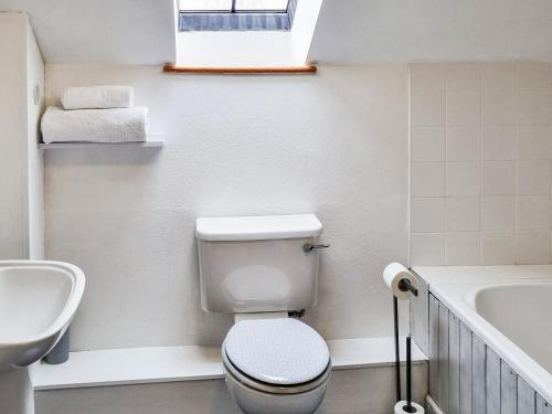 a bathroom with a toilet and a sink and a tub at Ty Nicw - W42765 in Blaenpenal
