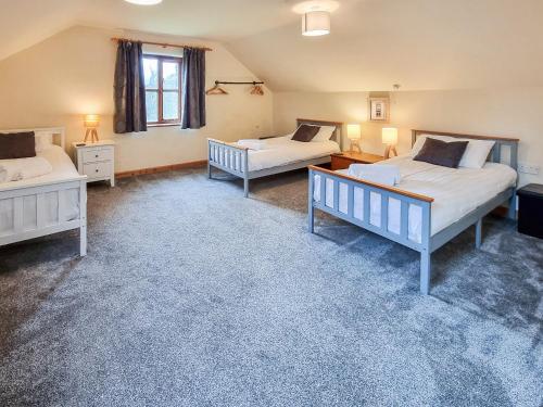 a bedroom with two beds and a window at Ty Nicw - W42765 in Blaenpenal