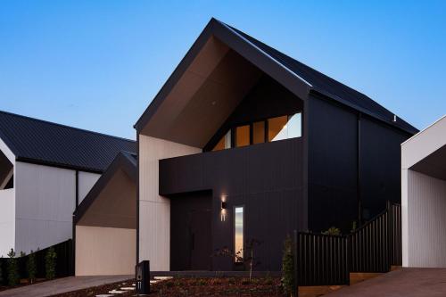 a black house with a black roof at Lux on Max- stunning design, amazing views in Daylesford