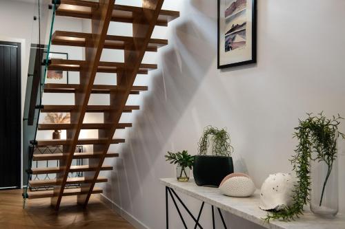 a spiral staircase in a living room with plants at Lux on Max- stunning design, amazing views in Daylesford