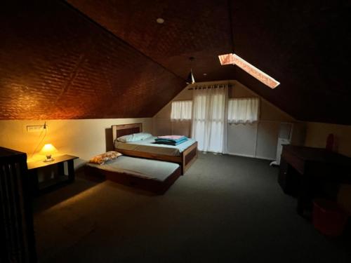 a large room with a bed and a window at Zyamadhari in Mananthavady