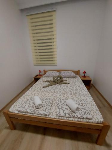 a bedroom with a bed with a bow on it at Platan 2 in Bela Crkva