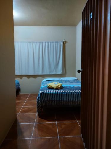 a bedroom with a bed sitting on a tiled floor at Hotel D Silva in Tochimilco