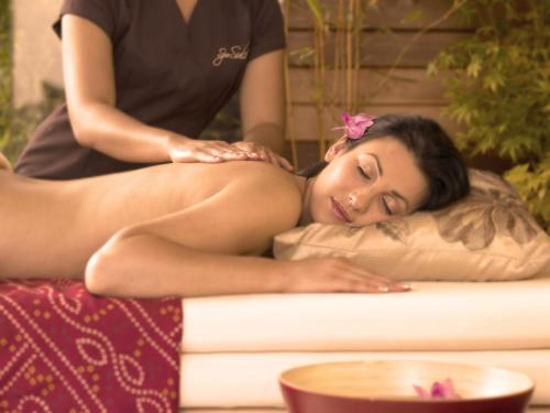 a woman getting a massage from a massage therapist at Westport Plaza Hotel, Spa & Leisure in Westport