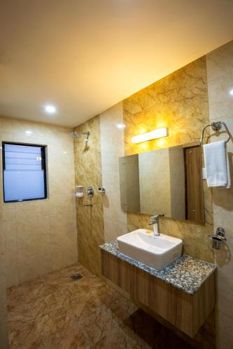 a bathroom with a sink and a mirror at Hotel Travel INN in Kathmandu