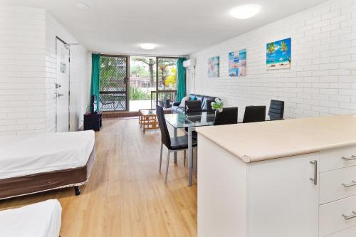 a room with a table and chairs and a dining room at Trickett Gardens Holiday Inn in Gold Coast