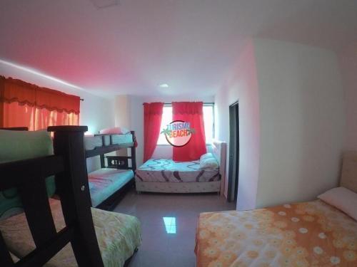a bedroom with two bunk beds and a window at Special Life Beach in Tubará
