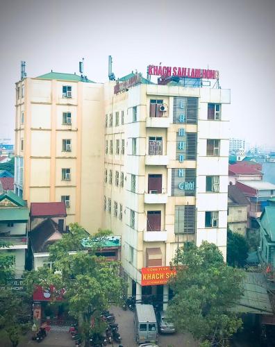 a tall building with a sign on top of it at Lam Hong Hotel in Xuân Ðài