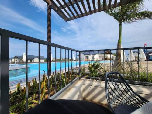 balcón con vistas a la piscina en BALLITO HILLS, 1 bedroom apartment, en Ballito