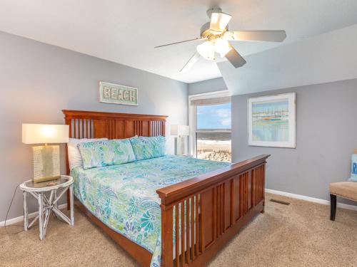 a bedroom with a bed and a ceiling fan at Tybee Lights 110C in Tybee Island