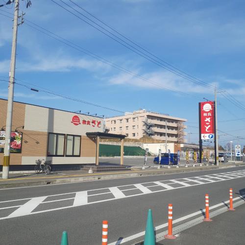 an empty street with a building in the background at ADD House Nara in Kanmaki