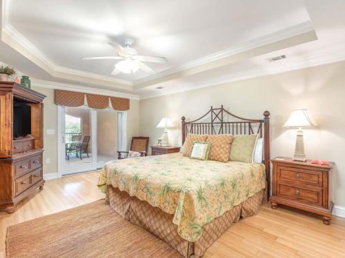 a bedroom with a bed and a ceiling fan at Brass Rail 316 in Tybee Island