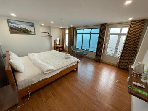 1 dormitorio con 1 cama en una habitación con suelo de madera en Flaco Hostel Sapa en Sa Pa