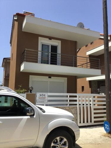 a white car parked in front of a house at Natalia House in Nikiti