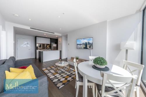 a living room with a couch and a table at Melbourne Private Apartments - Collins Wharf Waterfront, Docklands in Melbourne