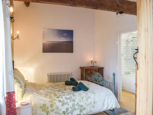 a bedroom with a bed and a window at Pipistrelle Cottage - Uk34447 in Mathry