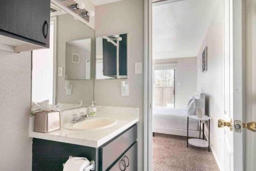 a bathroom with a sink and a mirror at LuxCation At Med Center Free Parking & WIFI in Houston