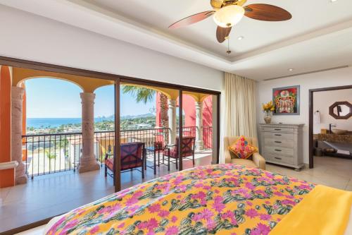 a bedroom with a bed and a balcony at Villas At Hacienda Encantada in Cabo San Lucas