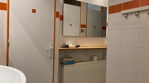 a bathroom with a sink and a mirror at Moulin de la Fayolle in Blot-lʼÉglise