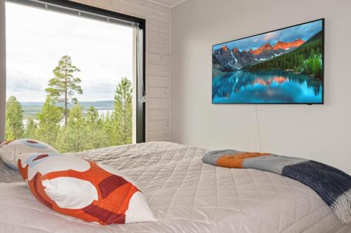 a bedroom with a bed and a large window at Villa Horihane - Modern Villa with panoramic view in Ivalo