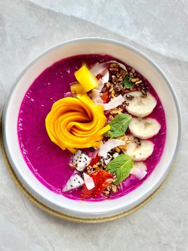 a plate of food with a purple soup on a table at Marine Bay Sanur in Sanur