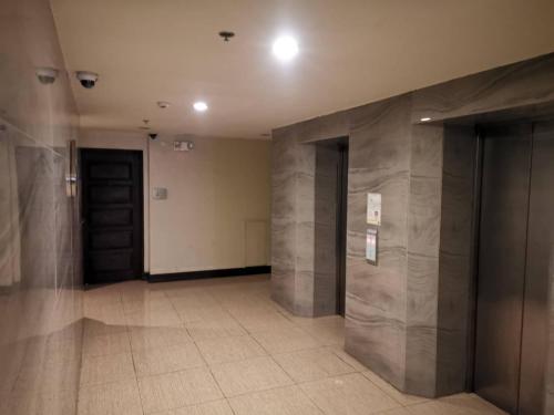 a hallway with two elevators in a building at Grand Residences Studio Unit - Walking Distance to IT Park in Cebu City