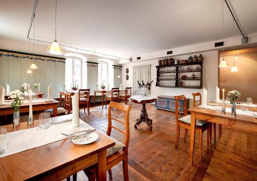 a large dining room with wooden tables and chairs at Romantik Hotel Meisenheimer Hof in Meisenheim