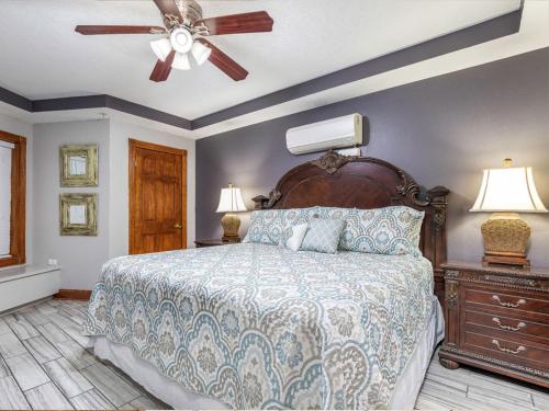 a bedroom with a bed and a ceiling fan at Colony 221 in Tybee Island