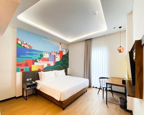 מיטה או מיטות בחדר ב-Parkside Alhambra Hotel Banda Aceh