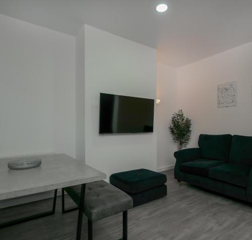 a living room with a couch and a table at Apex Living NE - Carnegie House 4 Bed House, FREE PARKING FREE WiFi in Ryhope