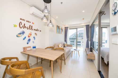 a living room with a table and a couch at The Song Luxury Condotel Vung Tau - Căn hộ cao cấp Luca's House in Vung Tau