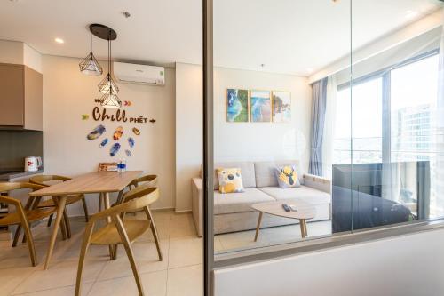 a living room and dining room with a couch and a table at The Song Luxury Condotel Vung Tau - Căn hộ cao cấp Luca's House in Vung Tau